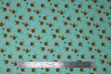 Flat swatch teal bee fabric (pale teal/aqua fabric with cartoon yellow and black bees tossed allover)