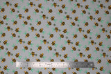 Flat swatch grey bee fabric (pale grey fabric with cartoon yellow and black bees with pale teal wings tossed allover)