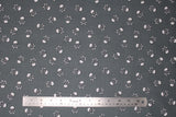 Flat swatch skulls fabric in grey (medium grey fabric with white small skull and crossbones tossed allover)