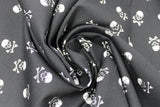 Swirled swatch skulls fabric in black (black fabric with white small skull and crossbones tossed allover)
