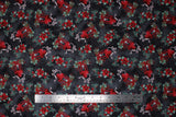 Flat swatch Candles fabric (black and grey marbled look fabric with busy tossed green and red holly and poinsettia clusters and tossed red candle lanterns)