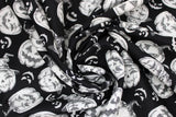 Swirled swatch Jackolantern fabric (black fabric with white jackolantern pumpkins allover with various faces, some with witch hats, some white faces only poking through black)