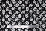 Flat swatch Jackolantern fabric (black fabric with white jackolantern pumpkins allover with various faces, some with witch hats, some white faces only poking through black)