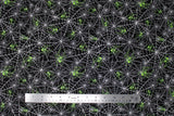 Flat swatch Spiderwebs fabric (black fabric with tossed white spiderwebs allover with lime green spiders tossed within)