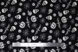 Flat swatch Spooky Toss fabric (black fabric with tossed black and white spooky emblems allover: spiderwebs, skull heads, bats, jackolanterns, etc.)