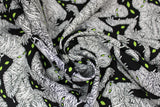 Swirled swatch Mumified fabric (black fabric with large tossed drawn/illustrative style wrapped mummies with glowing green eyes and tossed green eyes on black)