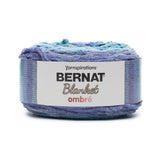 A cake of Bernat Blanket Ombre in colourway Shaded Blue (shades of blue with a bit of turquoise)