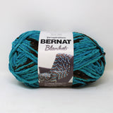 Ball of Bernat Blanket yarn in shade Mallard Wood (dark brown and medium teal shades)