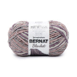 Ball of Bernat Blanket yarn in shade Purple Haze (faded purple, mauve and grey shades)