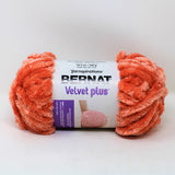 Bernat Velvet Plus yarn ball in coral haze (bright orange/pink)