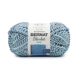 A ball of Bernat Blanket Twist in colourway Sea and Stars (soft turquoise twisted with grey and navy)