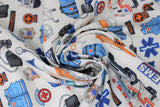 Swirled swatch paramedic white fabric (white fabric with small tossed full colour paramedic themed emblems: orange stretchers, blue vests and hats, "EMT/EMS" badges and text, blood pressure cuffs, scissors, etc.)