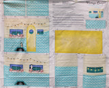 Full panel swatch Vintage Camper Sewing Machine Cover Panel - (45" x 35") (instruction panels and cut lines to create a sewing machine cover that looks like a vintage style camper: yellow door, white and blue camper with white polka dots, string lights, blue windows and curtains with floral and cats in windows)