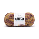 A ball of Bernat Symphony yarn in shade Autumn Maple (mustard yellows, browns and burnt oranges and reds in twisted shades)
