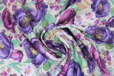 Swirled swatch violette fabric in mixed violettes white (white fabric with tossed purple violet heads in various purples and small floral and greenery layered)