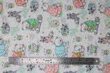 Flat swatch sleepy forest fabric (white fabric with tossed drawn forest animals wearing pjs in green, blue, and pink, racoons, bears, owls with tossed greenery, honey pots, etc.)