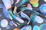 Swirled swatch planets fabric (dark blue space sky background with tiny white star dots allover and tossed circular planets in various sizes and colours)