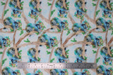 Flat swatch sleeping koala fabric (white/light blue pale sky look fabric with light brown branches allover and sleeping grey/blue koalas wearing green and pink flower crowns, holding greenery)