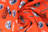 Swirled swatch NHL printed fabric in Edmonton Oilers (multi logo on orange)