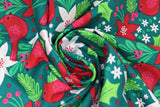 Swirled swatch Cardinal fabric (dark green fabric with brightly coloured tossed christmas graphics: red cardinals, white and red flowers, greenery, red berries, etc. all in a drawn style)
