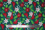 Flat swatch Cardinal fabric (dark green fabric with brightly coloured tossed christmas graphics: red cardinals, white and red flowers, greenery, red berries, etc. all in a drawn style)