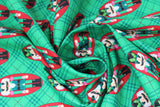 Swirled swatch Nutcrackers fabric (green and subtle black diagonal plaid fabric with red oval badges with green nutcrackers within)