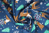 Swirled  swatch Reindeer fabric (navy fabric with tossed brown reindeer with tree branch antlers, some with red and green holly/leaves, tossed green trees and white snowflakes and dots)