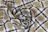 Swirled swatch Plaid fabric (white, grey and black plaid with gold sparkle lines)