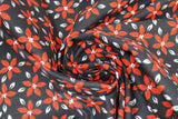 Swirled swatch Poinsettia fabric (black fabric with tossed red floral heads and grey leaves)