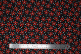 Flat swatch Poinsettia fabric (black fabric with tossed red floral heads and grey leaves)