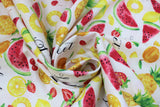 Swirled swatch Fruit Toss fabric (white fabric with tossed summer fruits allover and "life is sweet" text)