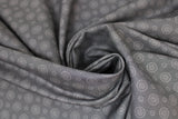 Swirled swatch fireworks fabric (dark grey fabric with light grey concentric circle dot pattern in small and medium)
