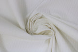 Swirled swatch white cotton fabric in style Harlequin (organic geometric diamond like shape allover)