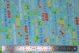 Flat swatch toadally cool glow print fabric (light blue/aqua fabric with tossed frogs/toads in green and orange with primary coloured frog related text "Hop to it" "Green" etc.)