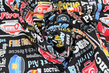 Swirled swatch emergency services themed print fabric in first responders (black fabric with multi-coloured emergency related text "Rescue" "First Aid" etc and emergency vehicles)