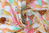 Swirled swatch icecream fabric (white fabric with layered ice cream cones regular and waffle with coloured ice cream scoops pink, orange, green, brown, yellow colourway)