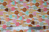 Flat swatch icecream fabric (white fabric with layered ice cream cones regular and waffle with coloured ice cream scoops pink, orange, green, brown, yellow colourway)