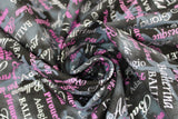Swirled swatch ballet fabric (black and grey marbled look fabric with small tossed light grey/white ballerina dancer silhouettes in various poses, horizontal and vertical text allover in white and pink, dance related words "Ballet" "Pirouette" etc.)