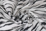 Swirled swatch white tiger print fabric (white fabric with black stripes and fur look texture)