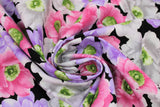 Swirled swatch Pink/Purple/Black fabric (black fabric with tossed large floral heads in white, pink, and purple with green and yellow centers)