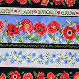 Square swatch poppie meadows fabric (medium thick black stripes with red poppies and greenery, thin white stripe with "Sprout" "Grow" etc. text in green, thick sky stripe with poppies and blue floral and hummingbirds, floral stripes)