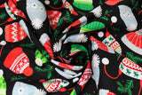 Swirled swatch hats fabric (black fabric with tossed Christmas/winter style cartoon hats in red, green, white, grey in various styles with tossed holly and tree sprigs)