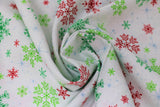 Swirled swatch snowflakes fabric (white fabric with tossed red and green snowflakes allover in various shapes and styles, pale blue star shines in background)