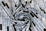 Swirled swatch Bricks fabric (brick pattern allover in white outline with grey and black shades of bricks allover)