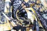 Swirled swatch halloween printed fabric in Spooky Collage (white, yellow, black colours skulls, birds, spooky patches)