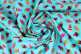Swirled swatch printed fabric from the Chili Smiles line in aqua (bright light blue/aqua fabric with tossed cartoon happy chilis in various styles including sunglasses, beige/black sun hat, open mouths, etc.)