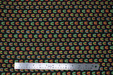 Flat swatch printed fabric from the Chili Smiles line in black rainbows (black fabric with small tiled colourful rainbow arches)