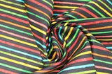 Swirled swatch printed fabric from the Chili Smiles line in black stripes (black fabric with individual horizontal rainbow coloured stripes)