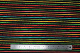 Flat swatch printed fabric from the Chili Smiles line in black stripes (black fabric with individual horizontal rainbow coloured stripes)