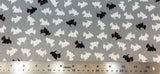 Flat swatch black and white scotty dogs fabric in grey (medium grey fabric with tossed scotty dog silhouettes in white, occasional black with red bandana)